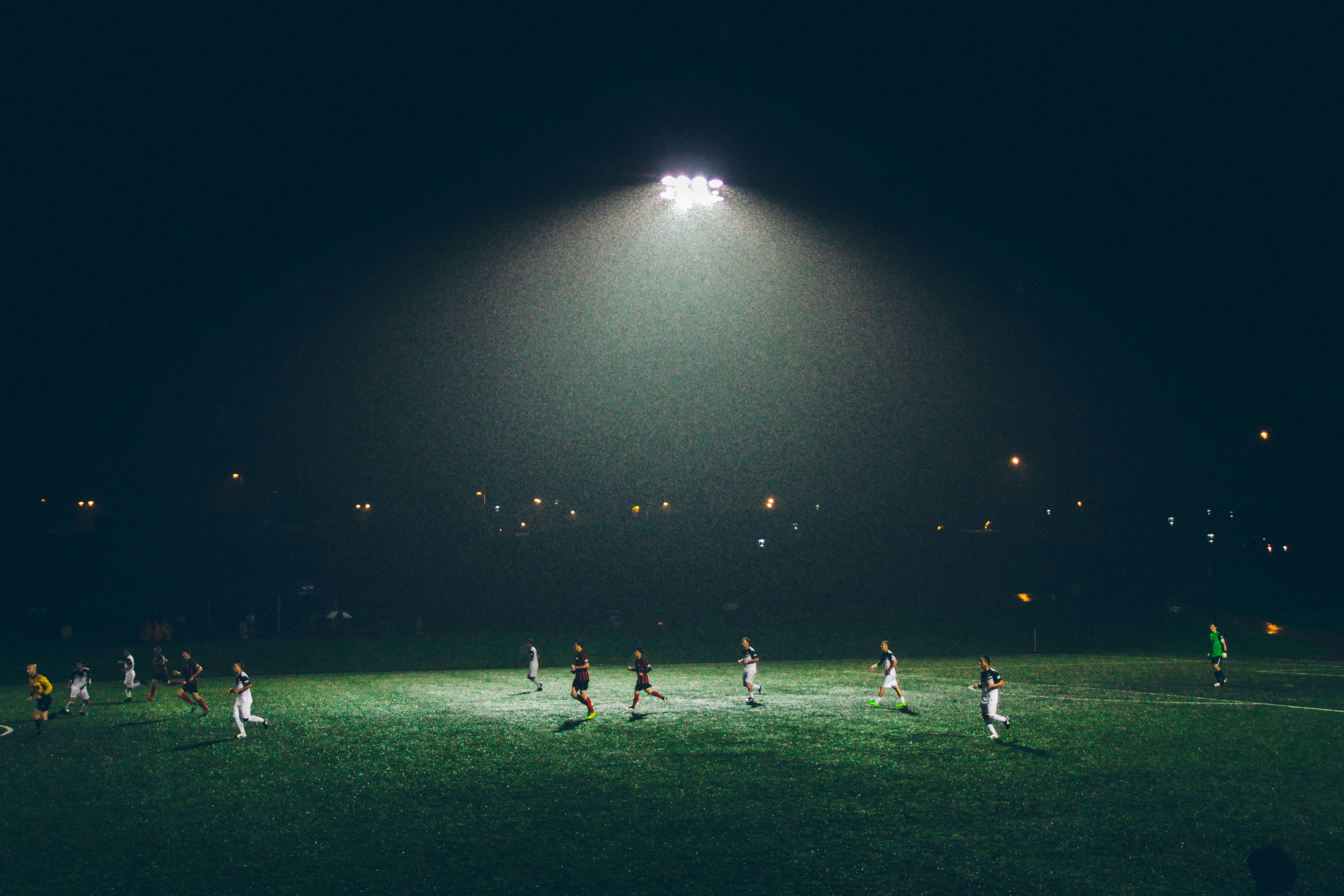 group of people playing soccer on soccer field